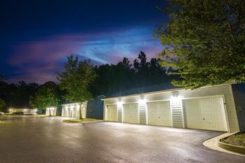 a garage with white doors at night under a purple sky